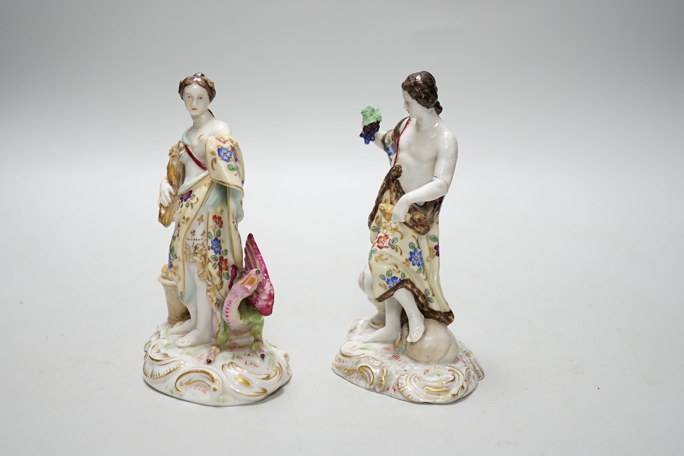 A pair of German Volkstedt porcelain figures including female with dragon, 15cm high